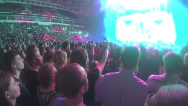 Muchos jóvenes disfrutan de una gran celebración en el estadio, filmando eventos por teléfono — Vídeo de stock