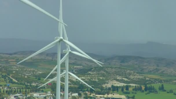 Vertikale Ansicht von sich drehenden Windkraftanlagen, erstaunliche ländliche Landschaft, regnerischer Horizont — Stockvideo