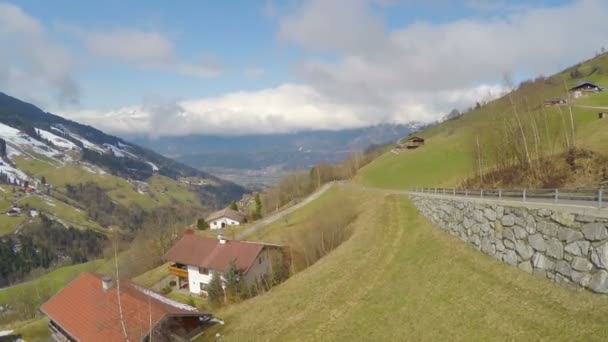 Aerial panorama of Alpine village on green mountain hills, cloudy sky, tourism — Stock Video