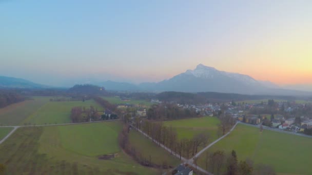 Panorama of green fields in rural area, rocky mountain on horizon, Austrian Alps — Stock Video