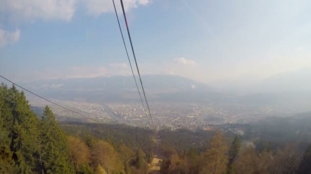 View from cableway cabin at evergreen forest, snow melting in mountains, spring — Stock Video