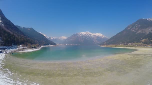 Vue imprenable sur les grandes montagnes enneigées, ciel bleu clair, beau lac — Video