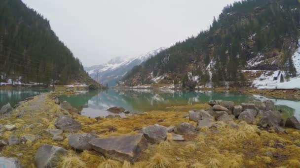 Piedra junto al lago en las montañas, líneas eléctricas, generación de energía alternativa — Vídeo de stock