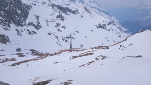 Cable cars moving at ski resort. Mountains covered with snow, winter landscape — Stock Video