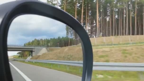 Roadside landscape reflected in side view mirror — Stock Video