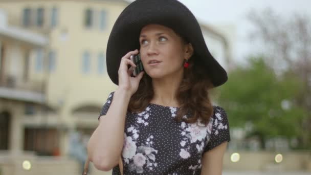 Bir toplantı için bekleyen güzel genç kadın şehir, telefon üzerine söz — Stok video