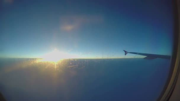 Beautiful sunrise in sky, plane wing seen through aircraft window, passenger pov — Stock Video