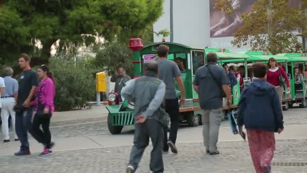 ATHENS, GREECE - JULY, 2014: People walking in the city. Happy tourists enjoying ride on wheel train, viewing city sites, having rest — Stock Video