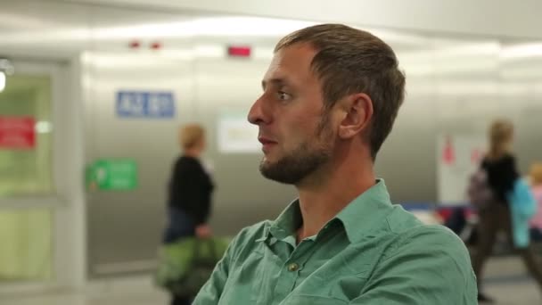 Emozioni di uomo ansioso in attesa di volo in aeroporto, guardandosi intorno nervosamente — Video Stock