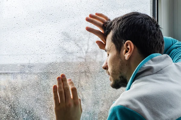 Tired young man suffering from acute pain, male drug addict at rehab clinic Stock Picture