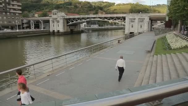 People walking and cycling along embankment — Stock Video