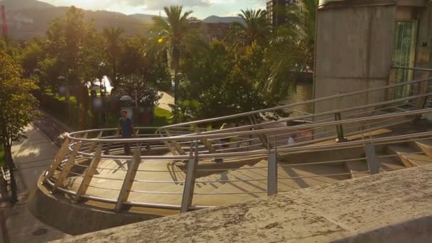 Guy with backpack walking up the stairs — Stock Video