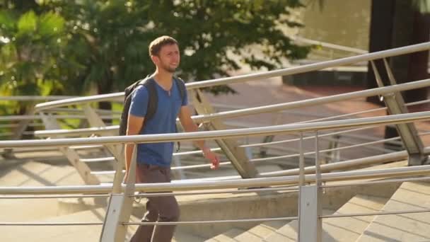 Positive courier walking up the stairs — Stock Video