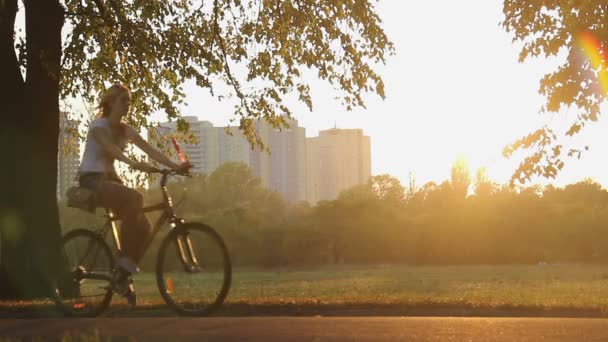 Female friends riding bicycles — Stock Video