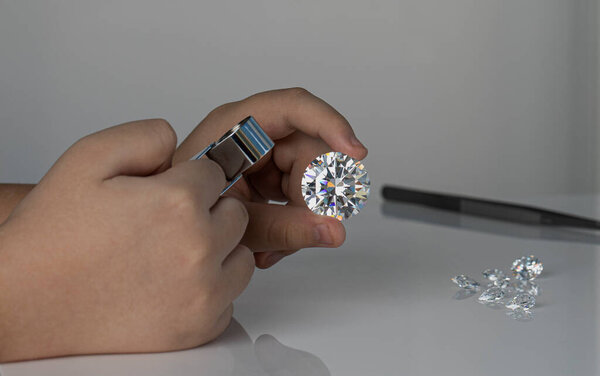 Jeweller hand holding diamonds. Diamond business in inspection and sales of brilliants. Jewelry gem precious stones. Luxury jewellery on the Sun light.