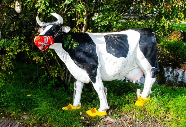 A wooden cow statue wearing a mask in Netherlands