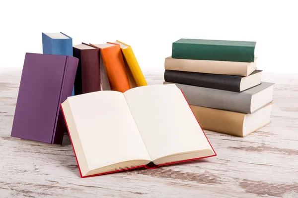 Pile of books with an open one — Stock Photo, Image