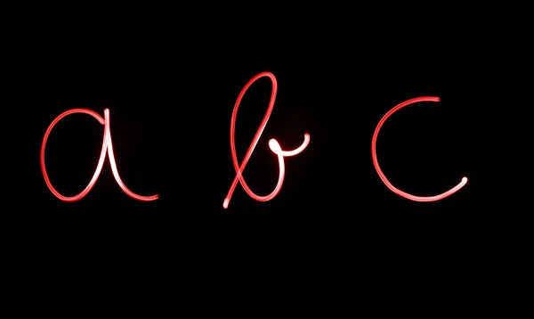 Letras fluorescentes 'abc' na cor de néon vermelho brilhante — Fotografia de Stock