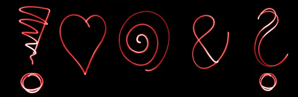 Différents symboles flourescents en couleur néon rouge — Photo