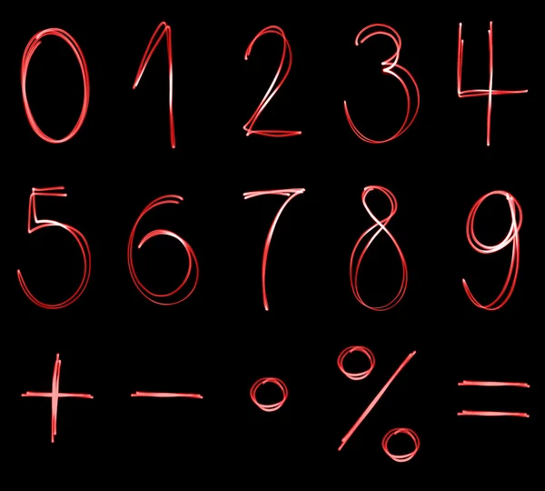 Verschiedene leuchtende Zahlen und mathematische Symbole in roter Neonfarbe — Stockfoto