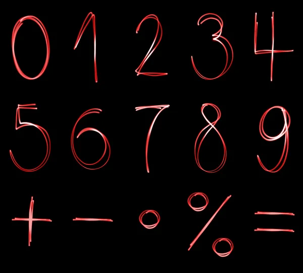 Different flourescent numbers and math symbols in red neon color — Stock Photo, Image