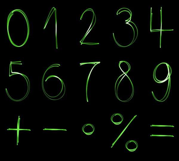 Différents nombres flourescents et symboles mathématiques en couleur verte néon — Photo