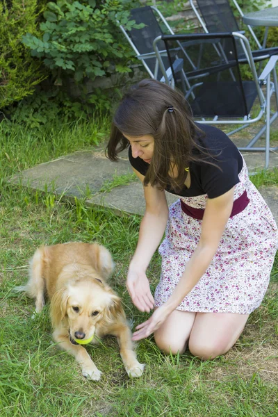 Cute girl petting dog outdoors — Stock Photo, Image
