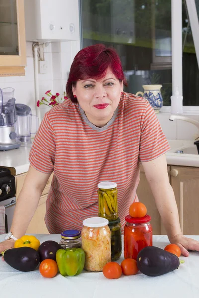 Mature woman with marinated vegetables — Stock Photo, Image