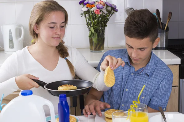 Brother and sister having breakfast — Stock Photo, Image