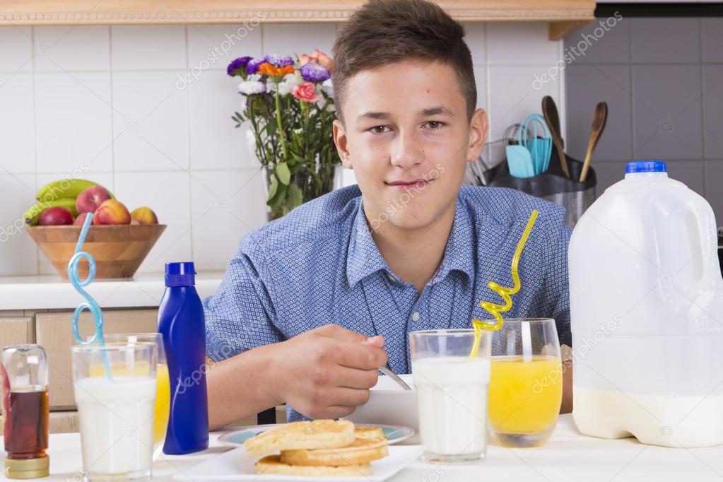Boy eating healthy breakfast at home