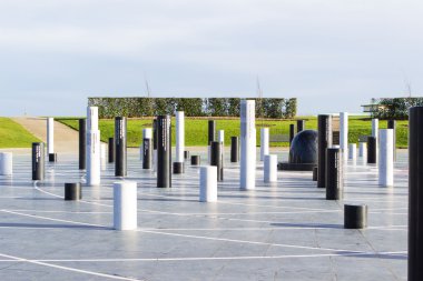 The MK Rose monument and pillars under cloudy sky, Milton Keynes clipart