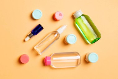 Kozmetik SPA marka modeli, fotokopi alanı olan üst görünüm. Renkli arka planda duran krema tüpleri ve kavanozları..