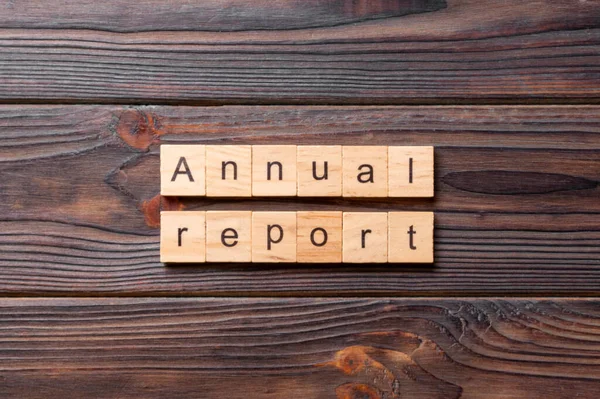 Annual report word written on wood block. Annual report text on cement table for your desing, concept.