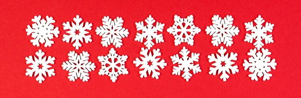 Banner top view of winter ornament made of white snowflakes on colorful background. Happy New Year concept with copy space.