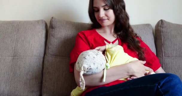 Mother breastfeeding baby at home. motherhood and maternity care concept. Cheerful mom enjoy breastfeeding — Stock Video