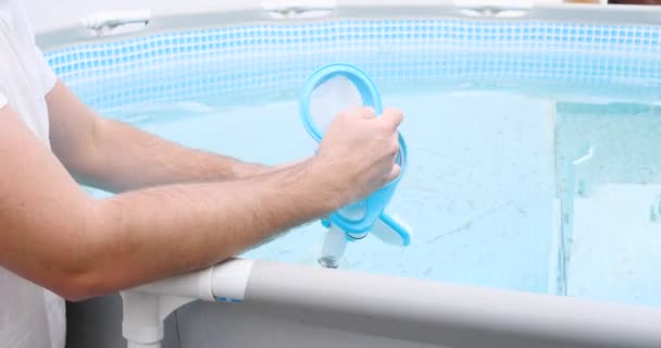 Man assembles a swimming pool vacuum cleaner and service and maintenance of the pool — Stock Video