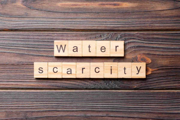 Water scarcity word written on wood block. Water scarcity text on cement table for your desing, concept.