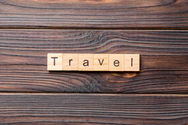 Travel word written on wood block. Travel text on cement table for your desing, concept.