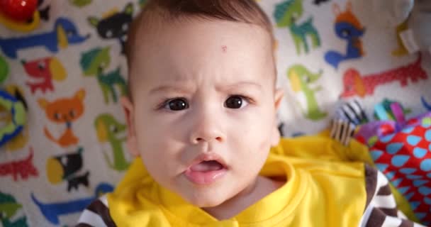 Милий маленький хлопчик малюк новонароджений портрет малюка посміхається до камери, дивлячись. повільний рух — стокове відео