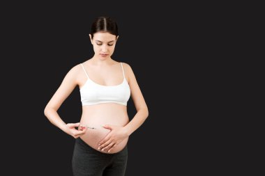 Hamile kadın karnına renkli arka planda fotokopi alanı ile insülin enjekte ediyor. Hamilelik sırasında şeker kontrolü.