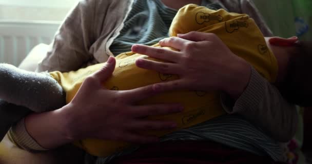 Mother breastfeeding her newborn baby on sofa. Milk from mothers breast is a natural medicine to baby. family, food, child, eating and parenthood concept. slow motion — Stock Video