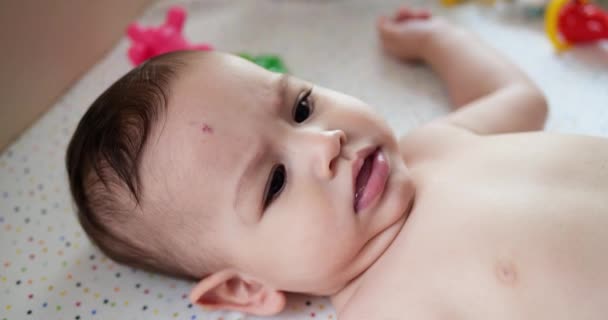 Infant, childhood concept - close-up of smiling happy Baby plays with a teether. Teeth cutting. First teeth. Joy toothless 7 months baby bite, gnaws teether toy. slow motion — Stock Video