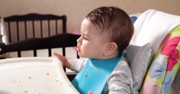 Mamá alimenta al niño con una cuchara y una mano, comida familiar y concepto de paternidad. primeros alimentos complementarios y autoalimentación — Vídeos de Stock