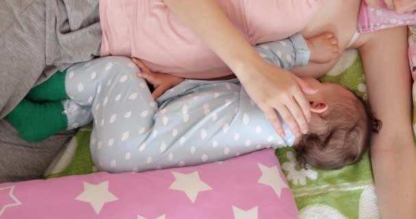 Mamma ammar sitt nyfödda barn på soffan. Mjölk från mödrars bröst är ett naturläkemedel till barnet. familj, mat, barn, mat och föräldraskap — Stockvideo