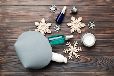 Noel dairesi renkli arka planda makyaj malzemeleriyle kozmetik poşetlerde yatıyordu. Üst Görünüm Yeni Yıl Güzellik Konsepti.