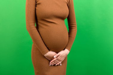 Hamilelik sırasında idrar tutamama. Hamilelik sırasında karın ağrısı. Renkli arka planda annelik sağlık konsepti.