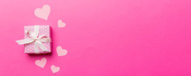 Sevgililer Günü kompozisyonu: Yay ve kalple kırmızı hediye kutusu. Noel hediyesi. Yukarıdan bak. Mesaj için yer var. Holday tebrik kartı.