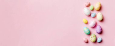 Happy Easter concept. Preparation for holiday. Easter eggs on colored background. flat lay top view copy space banner.
