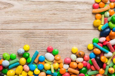 Renkli arka planda karışık renkli şeker koleksiyonu. Düz yerde, üst tarafta. Renkli çikolata kaplı şeker çerçevesi.