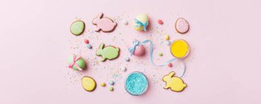 bayram hazırlığı renkli arka planda kurabiyeli çok renkli Paskalya yumurtaları. Pastel renginde Paskalya yumurtası. Kopyalama alanı olan tatil kavramı.